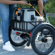 A photo of someone loading the cargo space on the RadTrike.